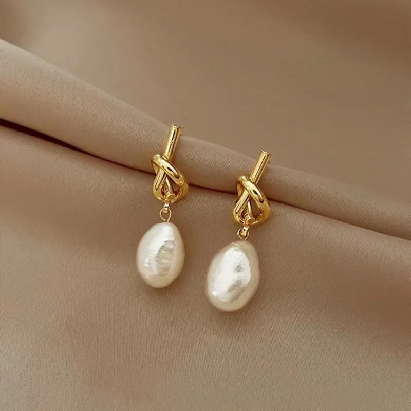 Pearl drop earrings on a gold-tone setting, King Watch