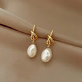 Pearl drop earrings on a gold-tone setting, King Watch