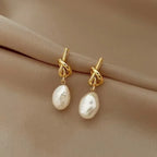 Pearl drop earrings on a gold-tone setting, King Watch
