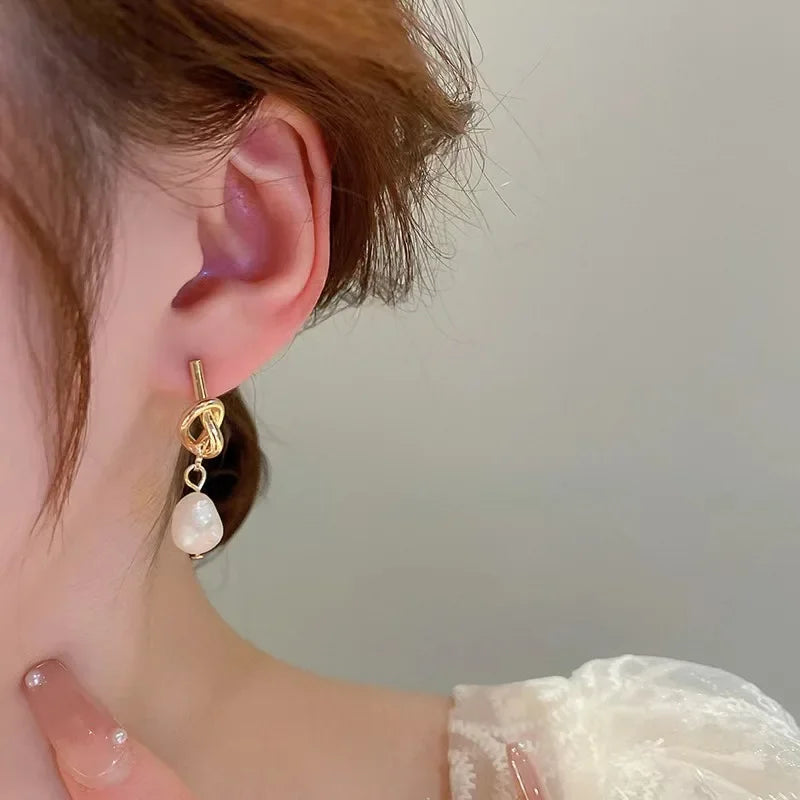 Pearl drop earrings on a gold-tone setting, view 5, King Watch